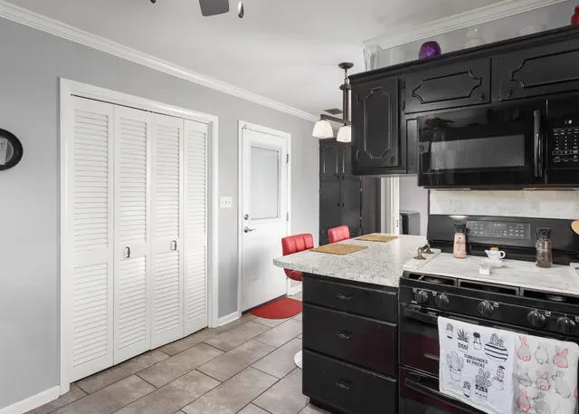 a kitchen with a sink stove and microwave