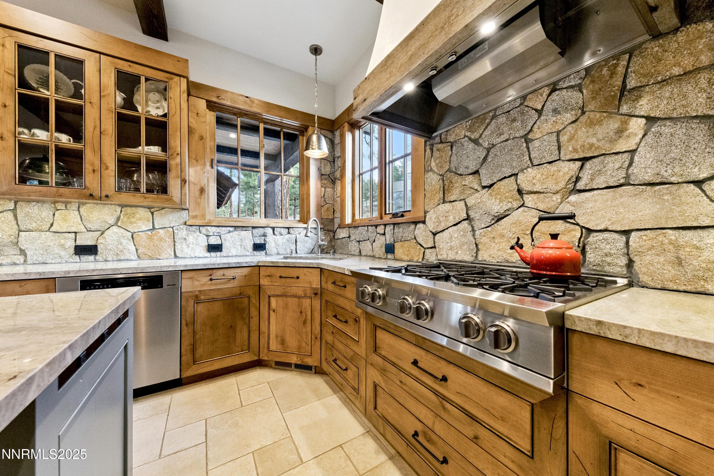 261 Redding Way Carson City, NV 89705 - Photo 23 of 90 a kitchen with stainless steel appliances granite countertop a stove and a sink