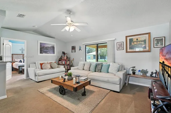 a living room with furniture and a large window