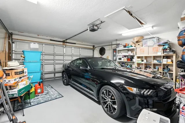 a view of a house with a yard and large tree