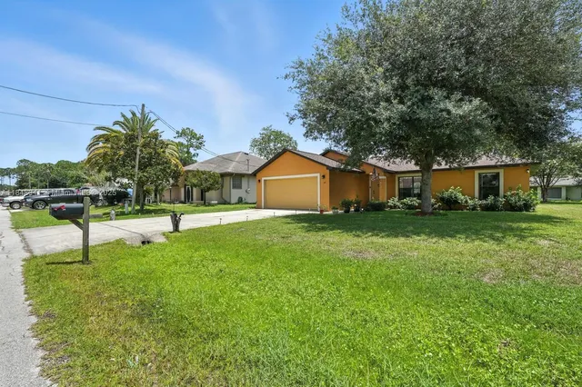 a front view of house with yard and green space