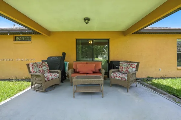 a outdoor living space with furniture and a yard