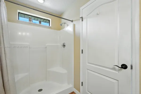 a bathroom with a glass shower door