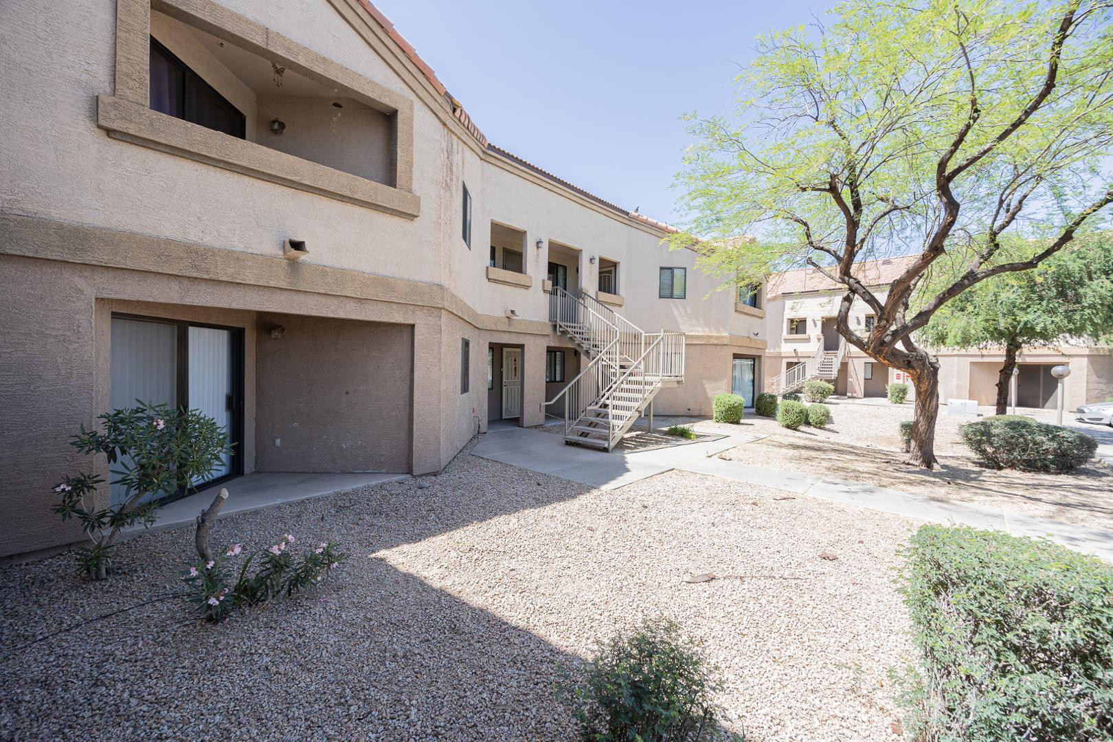 1287 North Alma School Road, Unit 131 Chandler, AZ 85224 - Photo 1 of 24 a view of a house with a yard and large tree
