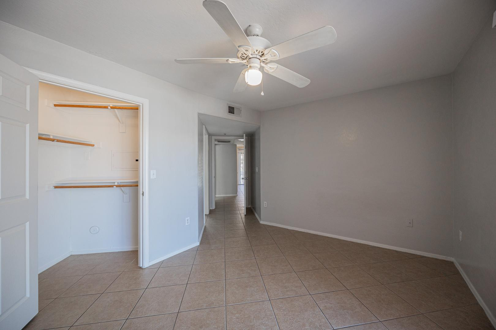 1287 North Alma School Road, Unit 131 Chandler, AZ 85224 - Photo 12 of 24 an empty room with fan and entrance