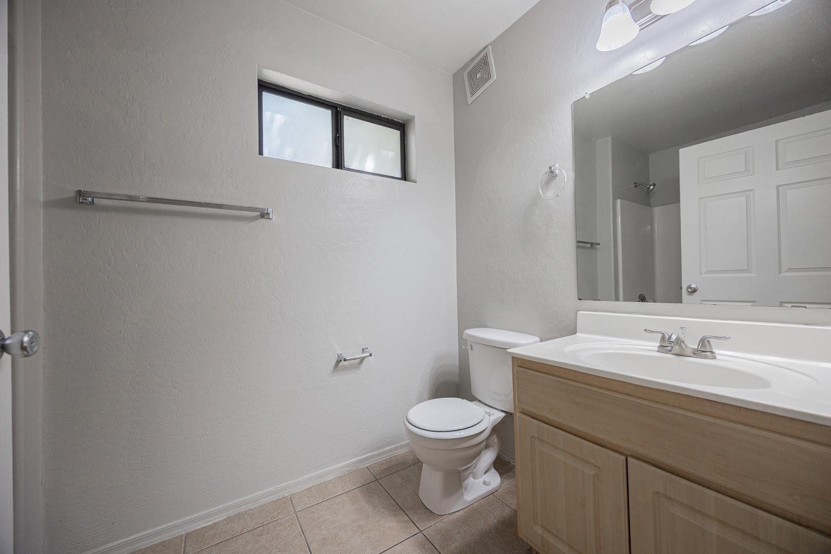 1287 North Alma School Road, Unit 131 Chandler, AZ 85224 - Photo 13 of 24 a bathroom with a toilet sink and mirror