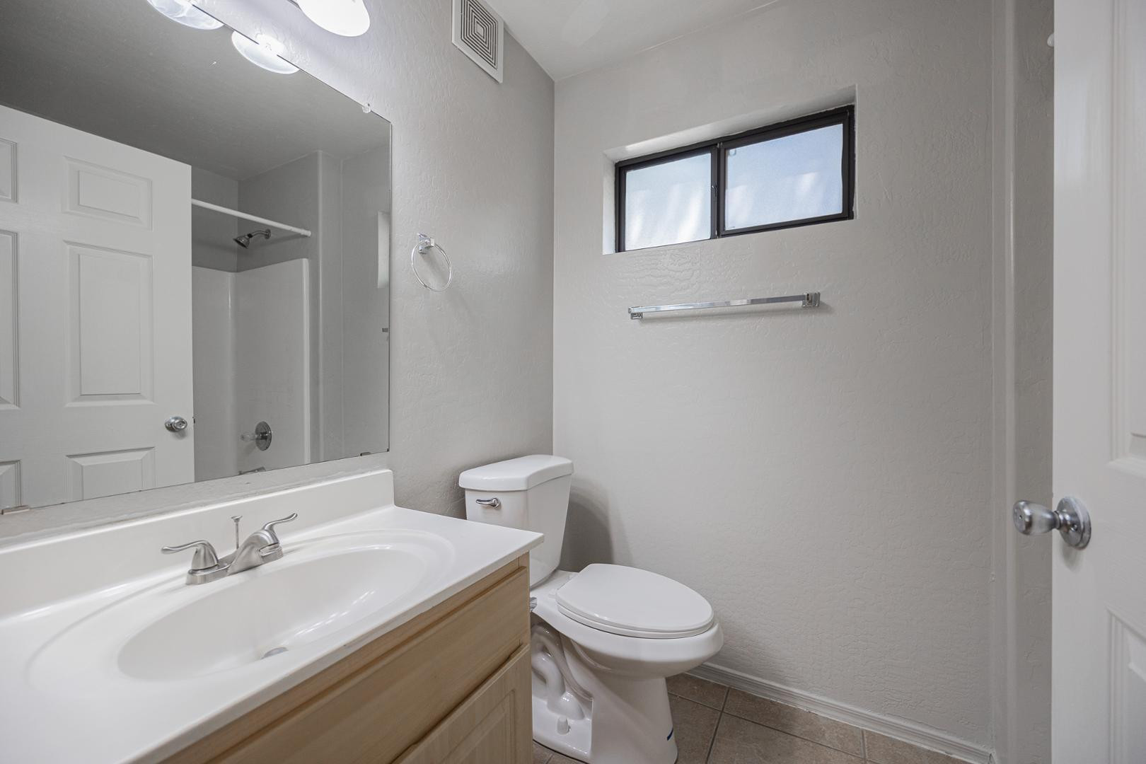 1287 North Alma School Road, Unit 131 Chandler, AZ 85224 - Photo 14 of 24 a bathroom with a toilet sink and mirror