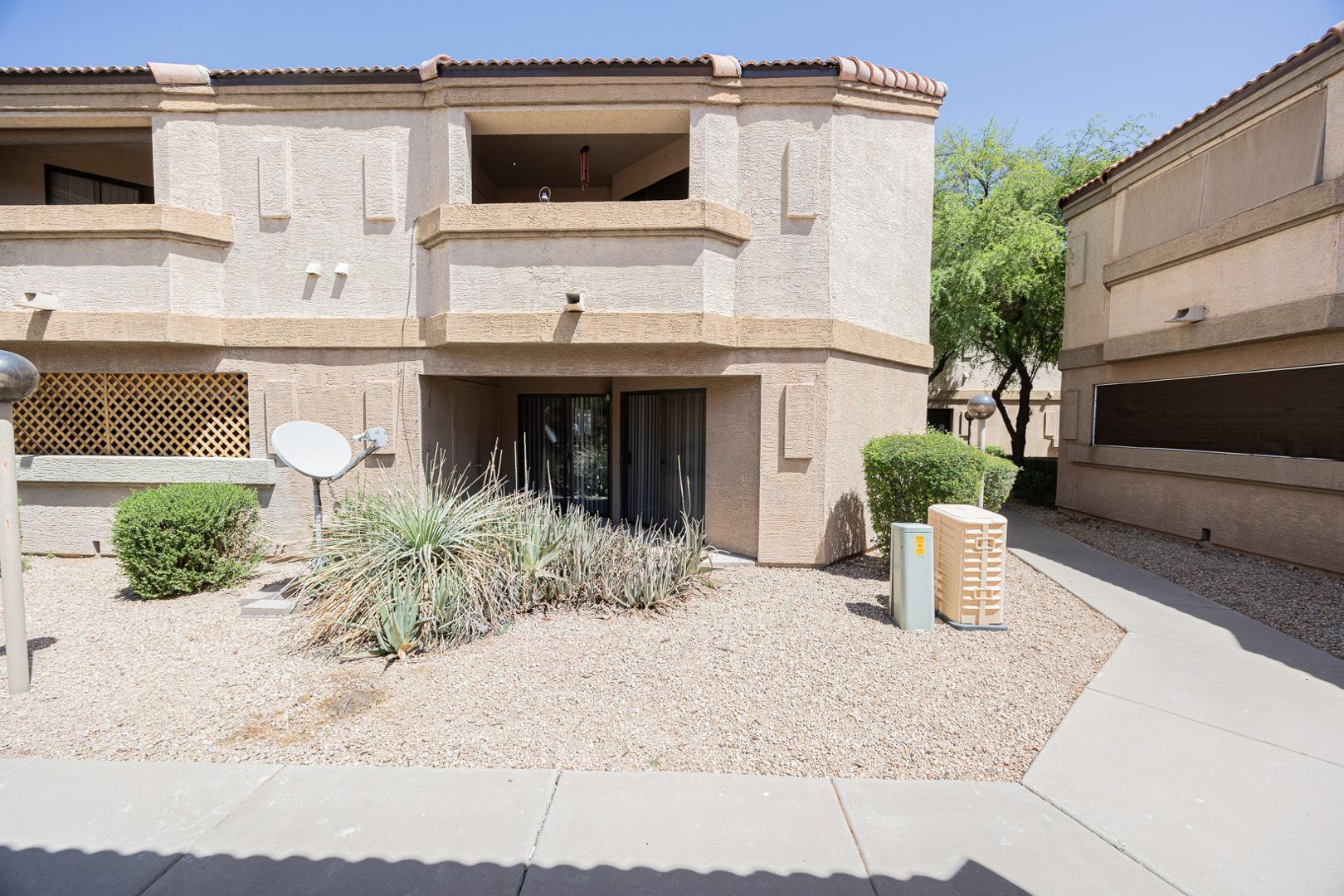 1287 North Alma School Road, Unit 131 Chandler, AZ 85224 - Photo 20 of 24 a front view of a house with a yard and potted plants