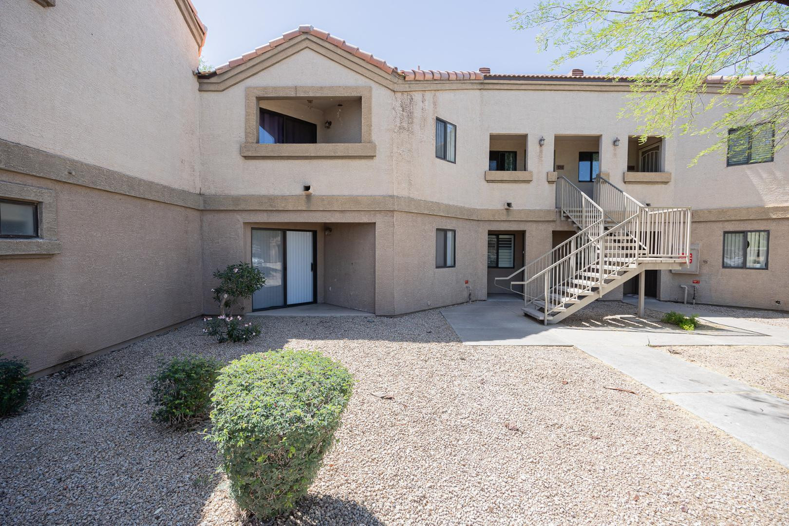 1287 North Alma School Road, Unit 131 Chandler, AZ 85224 - Photo 2 of 24 a front view of a house with garden