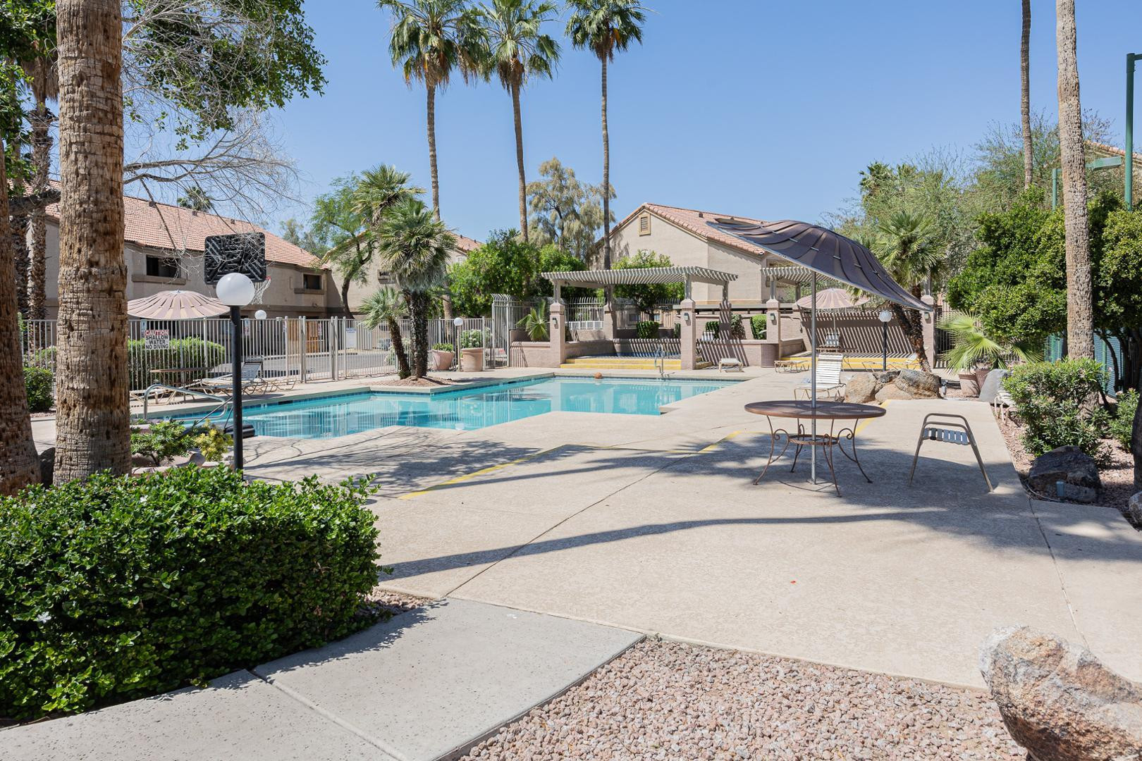 1287 North Alma School Road, Unit 131 Chandler, AZ 85224 - Photo 23 of 24 a front view of a house with a yard and potted plants
