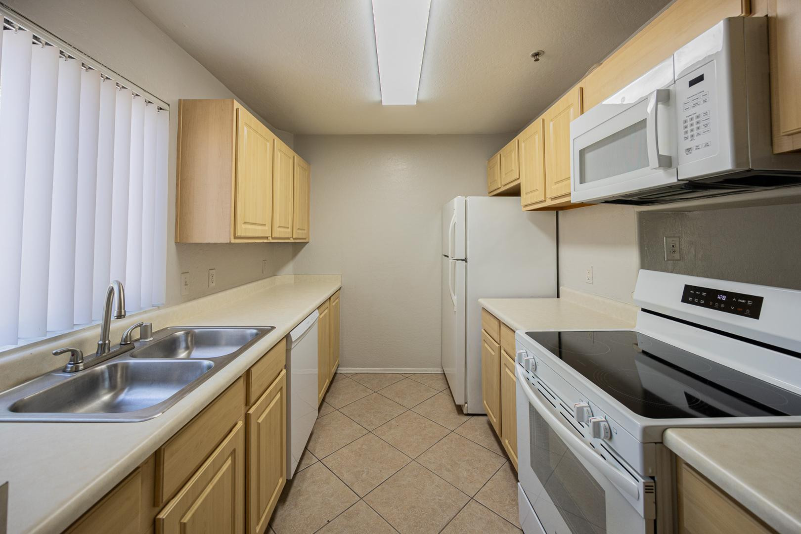 1287 North Alma School Road, Unit 131 Chandler, AZ 85224 - Photo 8 of 24 a kitchen with stainless steel appliances granite countertop a sink and a stove