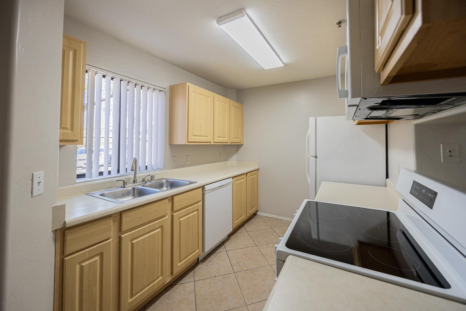 1287 North Alma School Road, Unit 131 Chandler, AZ 85224 - Photo 9 of 24 a kitchen that has a sink and a stove in it