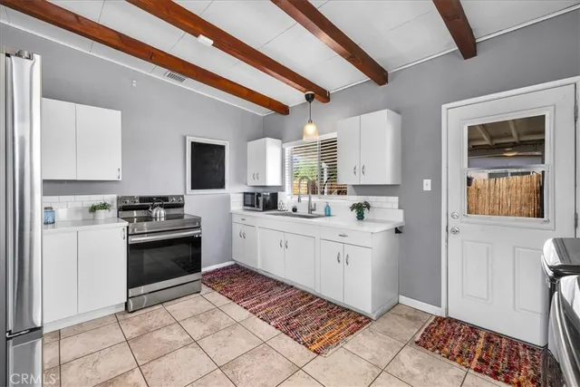 a kitchen with a stove top oven cabinets and a refrigerator