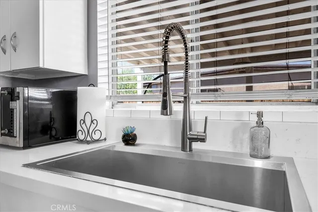 a view of a kitchen with a sink and cabinets