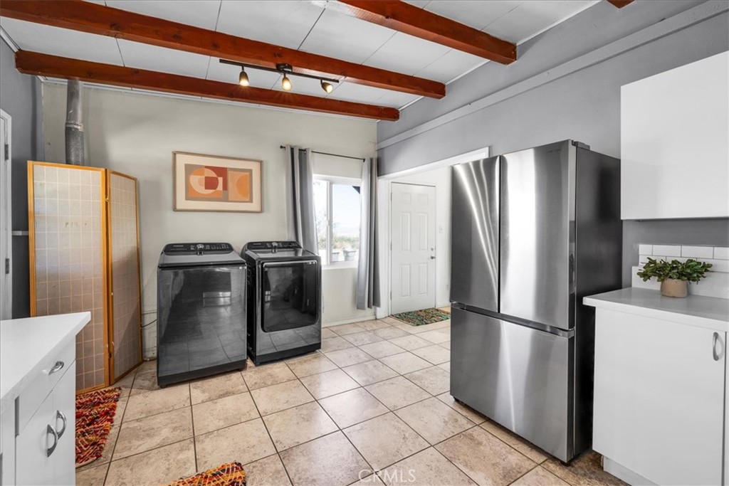 74825 Alta Loma Drive Twentynine Palms, CA 92277 - Photo 14 of 36 a metallic refrigerator freezer and a stove sitting inside of a kitchen