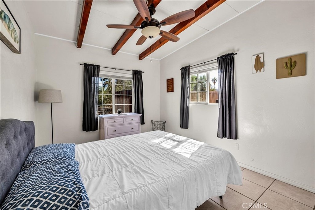 74825 Alta Loma Drive Twentynine Palms, CA 92277 - Photo 15 of 36 a bedroom with a large bed and a window