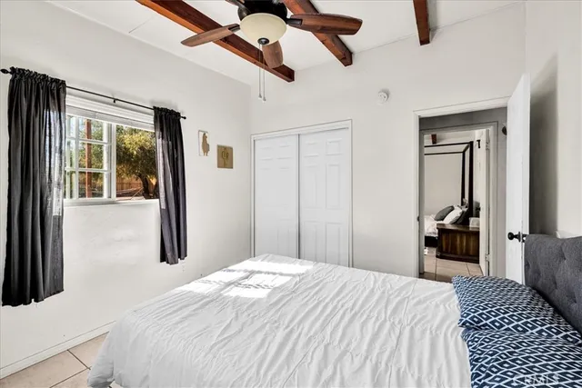 a bedroom with a bed and a large mirror