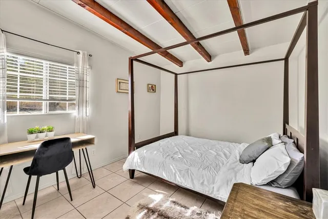 a bedroom with a bed window and couch