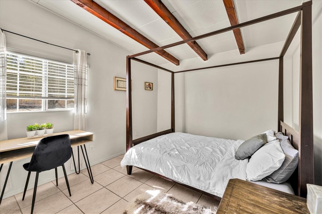 74825 Alta Loma Drive Twentynine Palms, CA 92277 - Photo 20 of 36 a bedroom with a bed window and couch