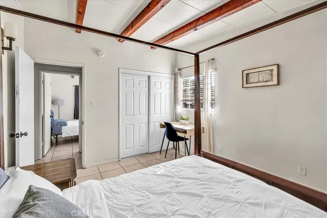 a bedroom with a bed and a chair with the view