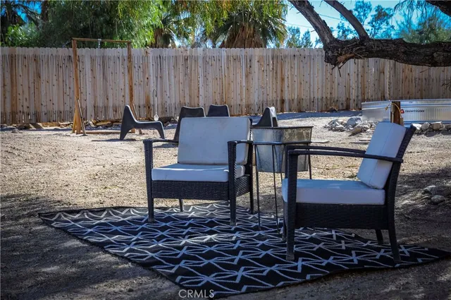 a backyard of a house with table and chairs