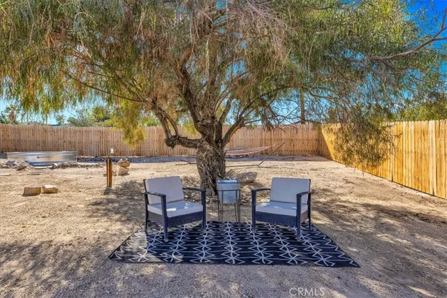 a backyard of a house with table and chairs