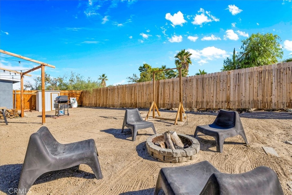 74825 Alta Loma Drive Twentynine Palms, CA 92277 - Photo 31 of 36 a view of a patio with couches chairs and potted plants