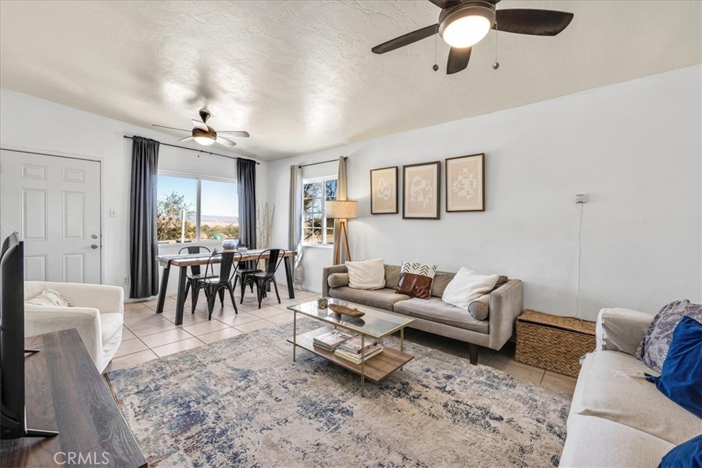74825 Alta Loma Drive Twentynine Palms, CA 92277 - Photo 5 of 36 a living room with furniture and a chandelier
