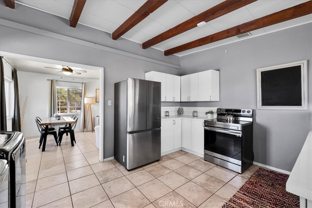 74825 Alta Loma Drive Twentynine Palms, CA 92277 - Photo 10 of 36 a kitchen with granite countertop a refrigerator and a stove top oven