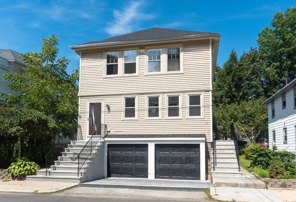 333 Vermont Street, Unit 2 Boston, MA 02132 - Photo 1 of 24 a front view of a house with garage