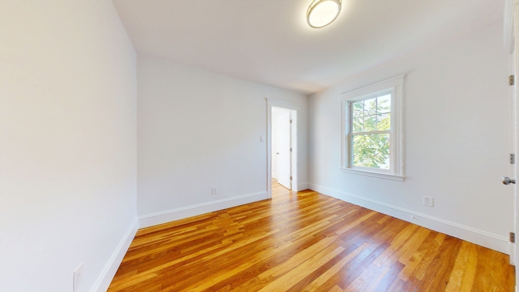 333 Vermont Street, Unit 2 Boston, MA 02132 - Photo 13 of 24 a view of room with window and wooden floor