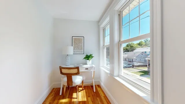 a view of a room with a table and chairs