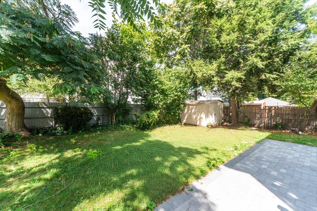 333 Vermont Street, Unit 2 Boston, MA 02132 - Photo 20 of 24 a view of a backyard with large trees and plants