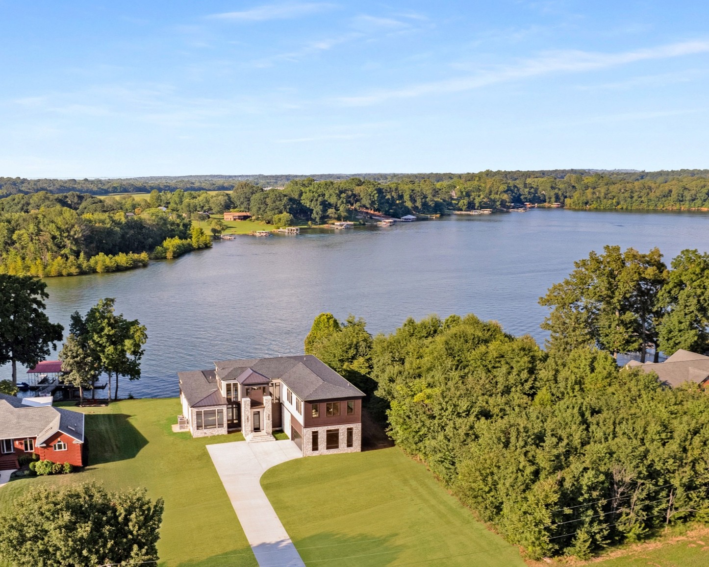 an aerial view of a house with a lake view