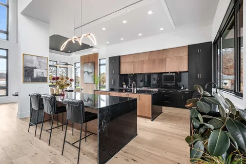 a kitchen with sink stove and cabinets