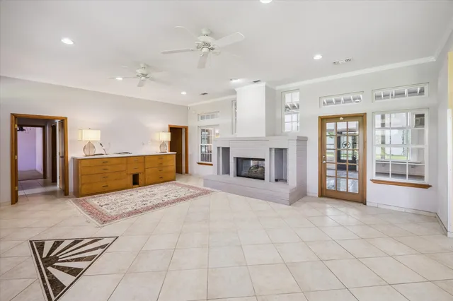 a spacious bedroom with a large bed and a chandelier