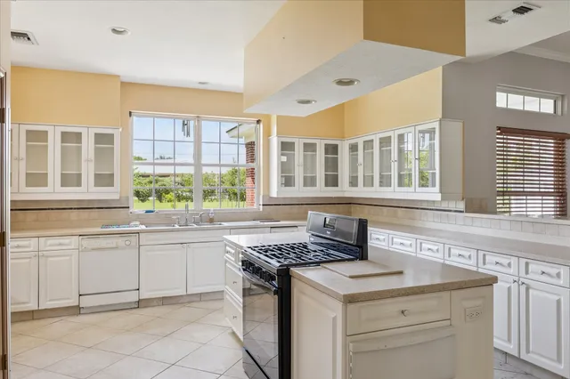 a kitchen that has a sink and a stove in it