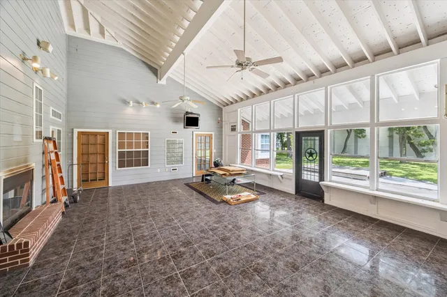 a view of a livingroom with furniture wooden floor and a ceiling fan