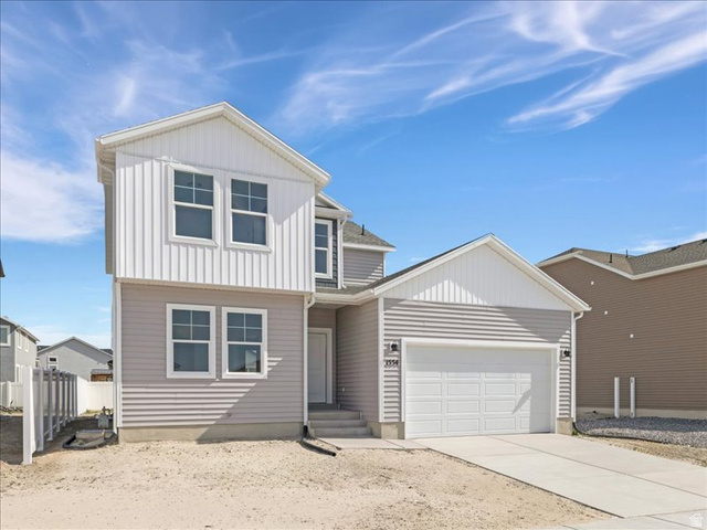 1554 Pheasant Road Eagle Mountain, UT 84005 - Photo 2 of 29 Two-story residence featuring light gray horizontal siding and white vertical siding accents