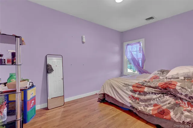 a bedroom with a bed and a book shelf