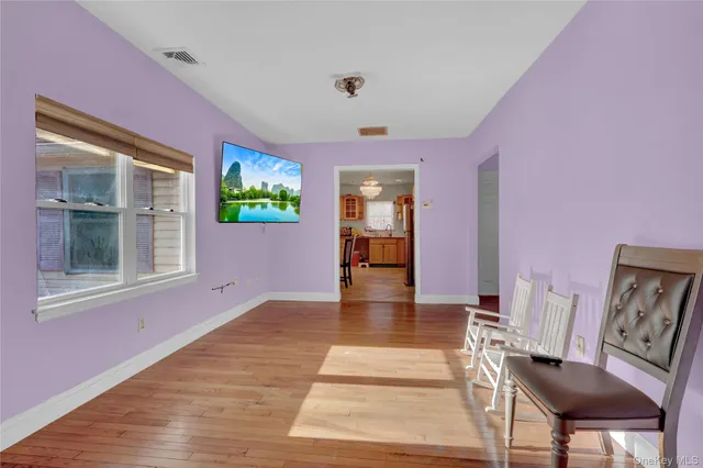 a view of livingroom with furniture wooden floor and windows