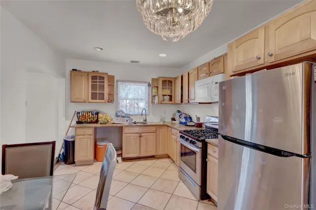 a kitchen with stainless steel appliances a refrigerator sink and cabinets