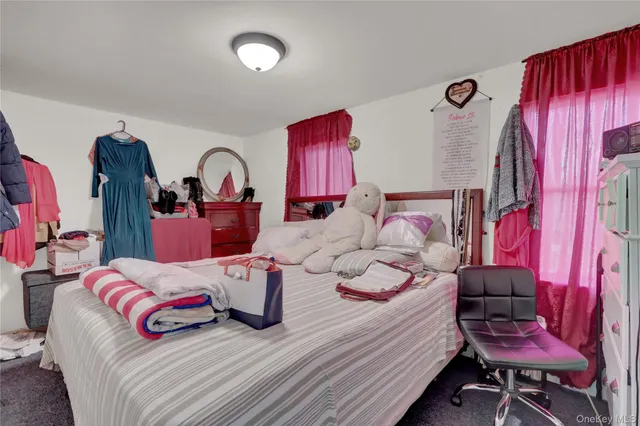 a bedroom with a bed and wooden furniture