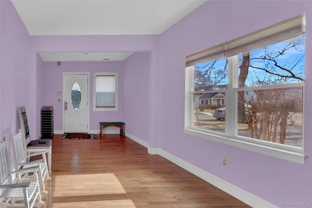 a view of an entryway with wooden floor