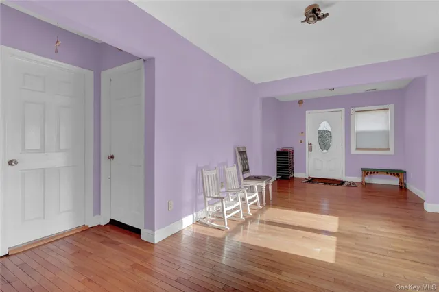 a view of a livingroom with wooden floor and furniture
