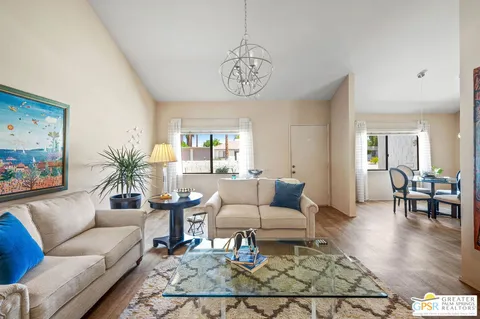 a view of a a dining room with furniture window and wooden floor