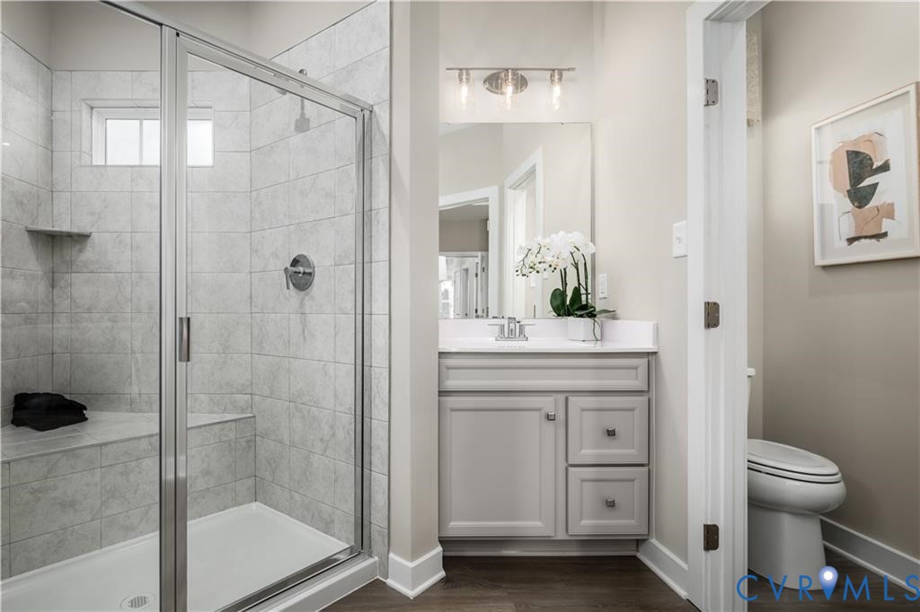 2806 Calgary Loop Chester, VA 23831 - Photo 12 of 20 a bathroom with a granite countertop sink a toilet and shower