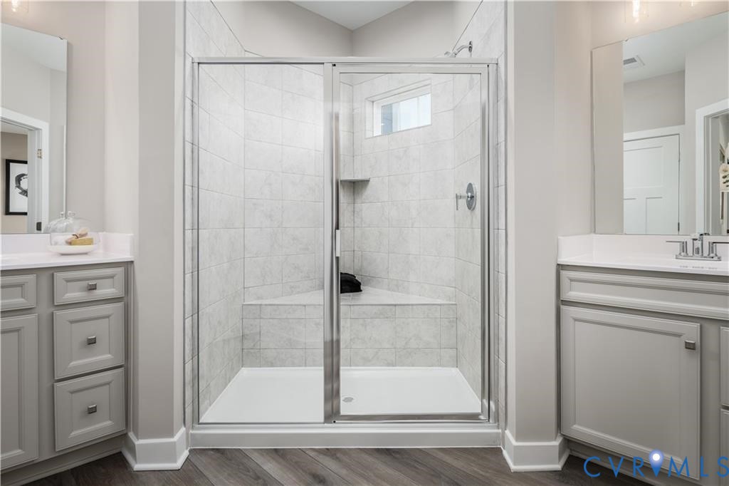 2806 Calgary Loop Chester, VA 23831 - Photo 10 of 20 a bathroom with a shower sink and mirror