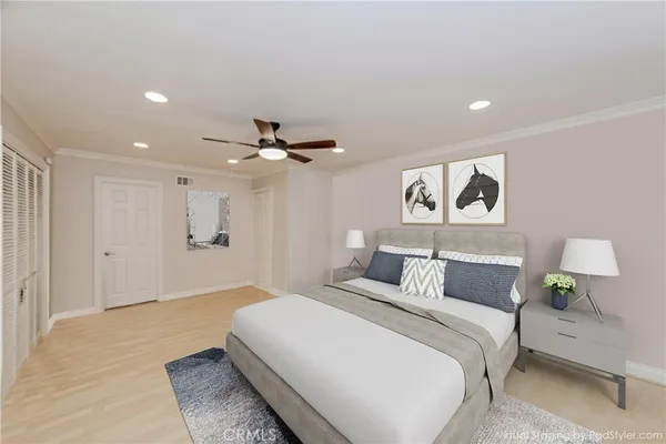 a bedroom with a bed and a painting on the wall