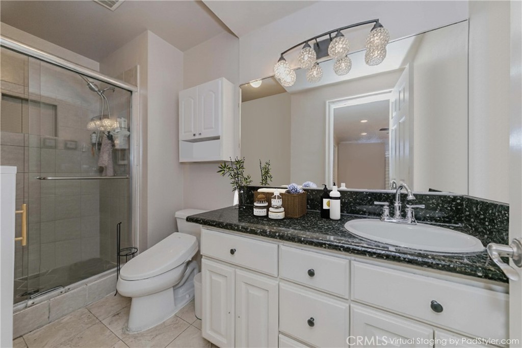 5431 Marion Avenue Cypress, CA 90630 - Photo 14 of 22 a bathroom with a granite countertop sink a toilet and shower